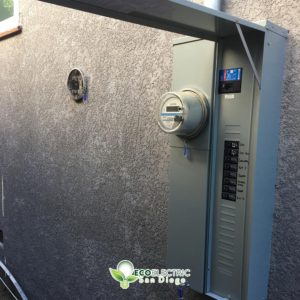 A single electrical meter installation with door swung upward